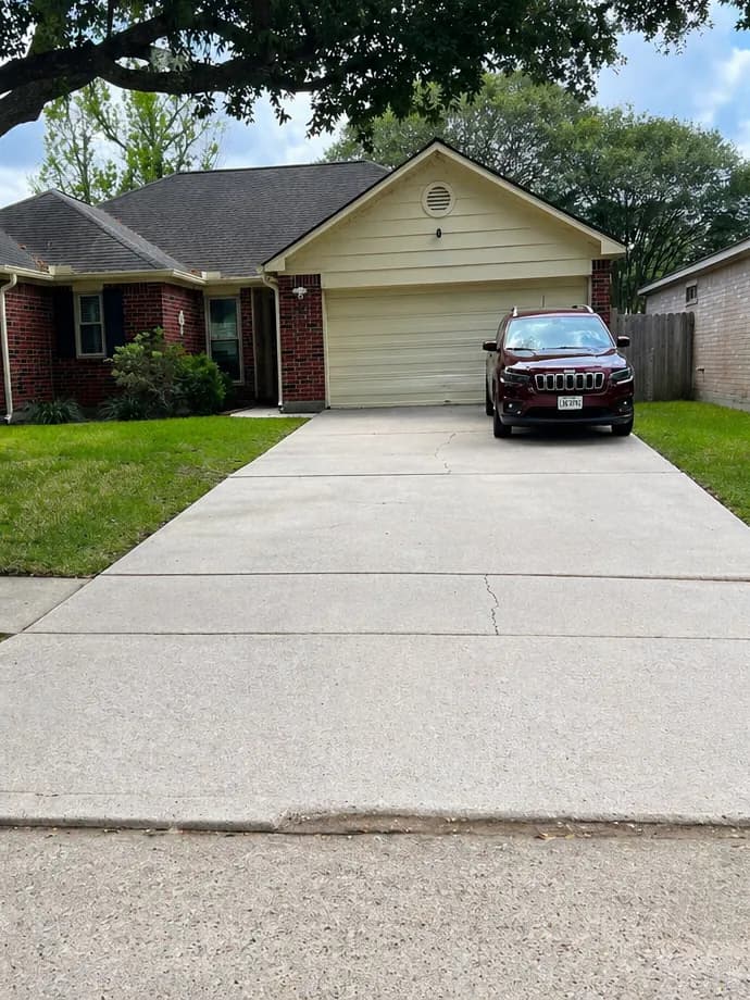 The same concrete driveway bright and even after pressure washing